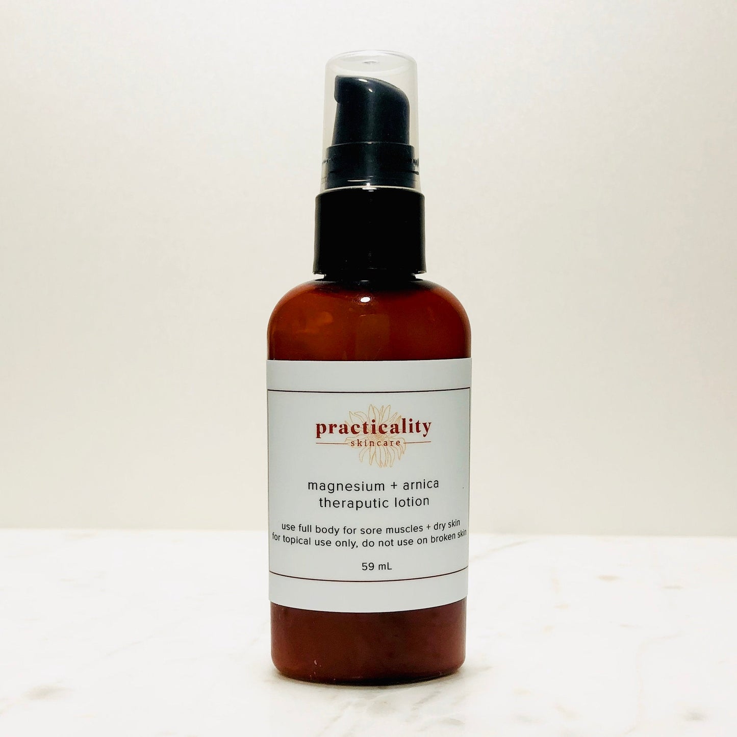 Magnesium and arnica body lotion in the 2 ounce travel size