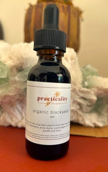Cold-pressed black seed oil bottle on a transparent background