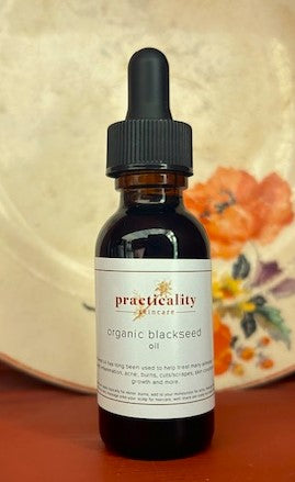 Cold-pressed black seed oil in a labeled bottle for topical skin, beard and hair care