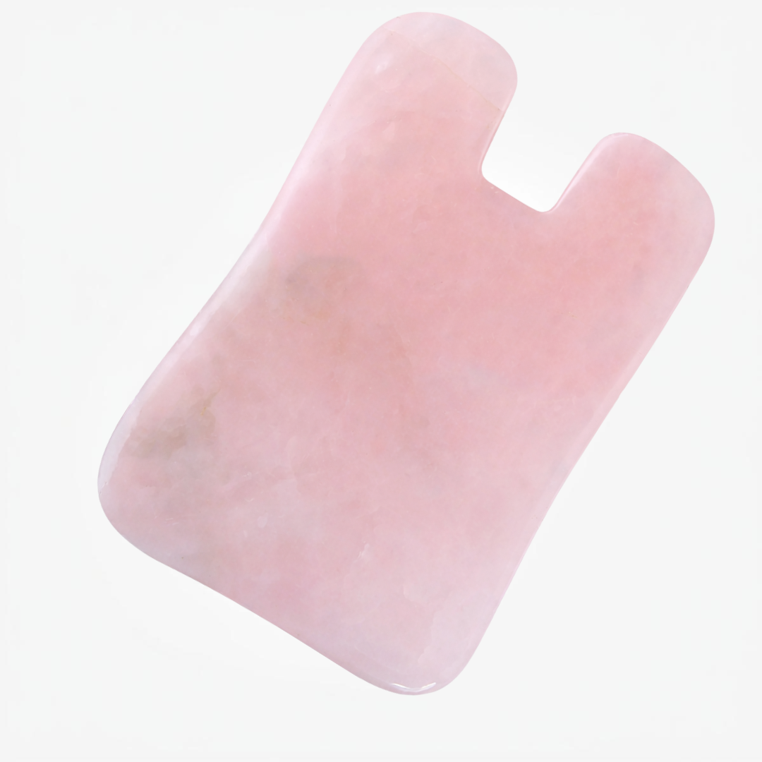 Close view of polished rose quartz facial gua sha tool