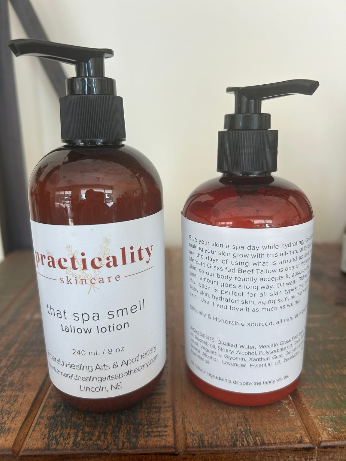 Practicality That Spa Smell Tallow Lotion 8 oz shown from the front and back on a wooden surface